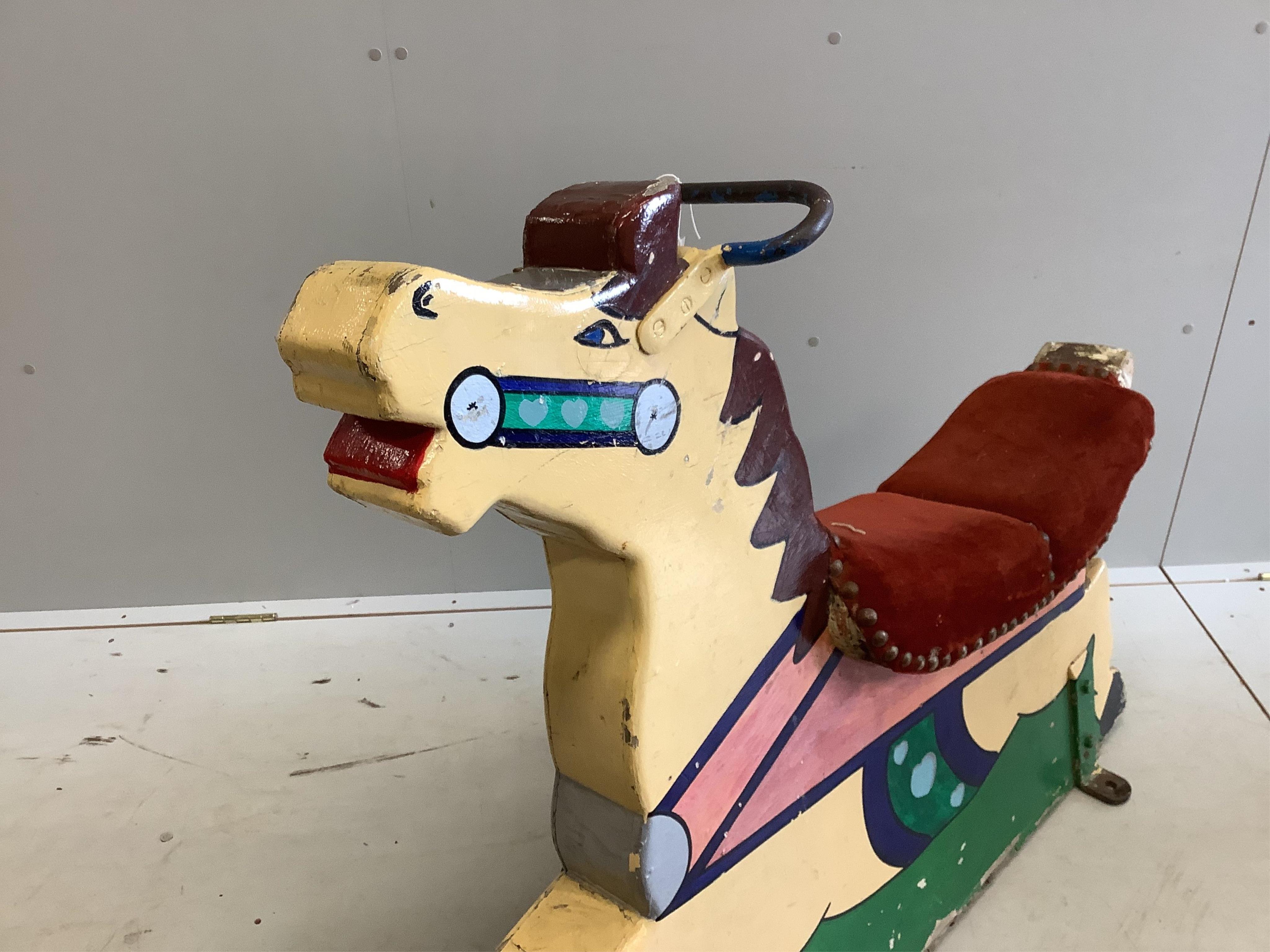 A mid 20th century carved painted wood fairground carousel horse, length 110cm, height 98cm. Condition - fair